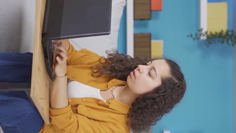 Vertikales-Video-Einer-Jungen-Frau,-Die-Auf-Einen-Laptop-Schaut,-Ist-Nachdenklich.